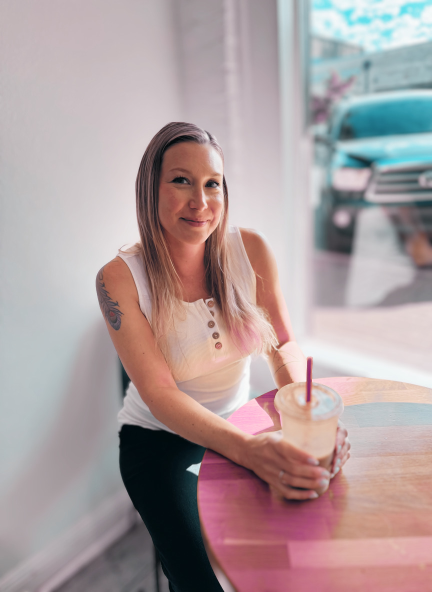 Mia Morales at a café, holding an iced coffee
